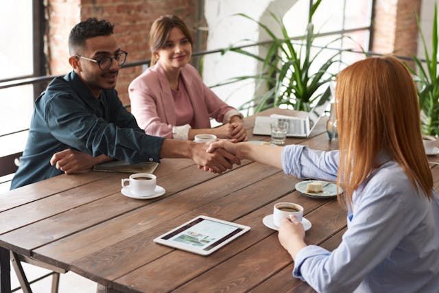 business partners shaking hands with Insurance Agent after buying Disability Buyout Insurance. ontariobusinessprotection.com can help