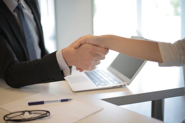 A handshake between business owner and ontariobusinessprotection.com agent. They used Immediate Financing Arrangement (IFA) as collateral for business funding.