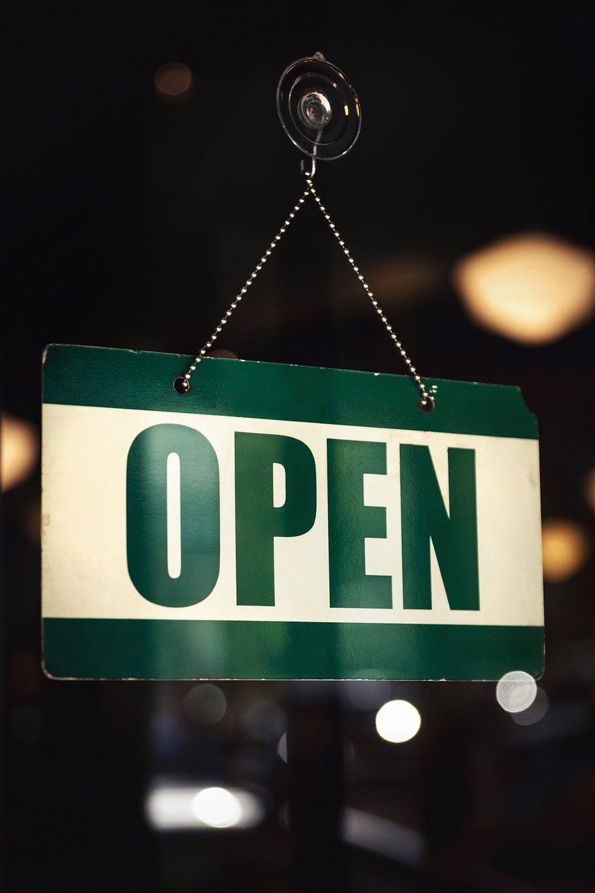 Open sign symbolizing how Business Overhead Expense (B.O.E.) insurance keeps Ontario small businesses operational during financial disruptions.